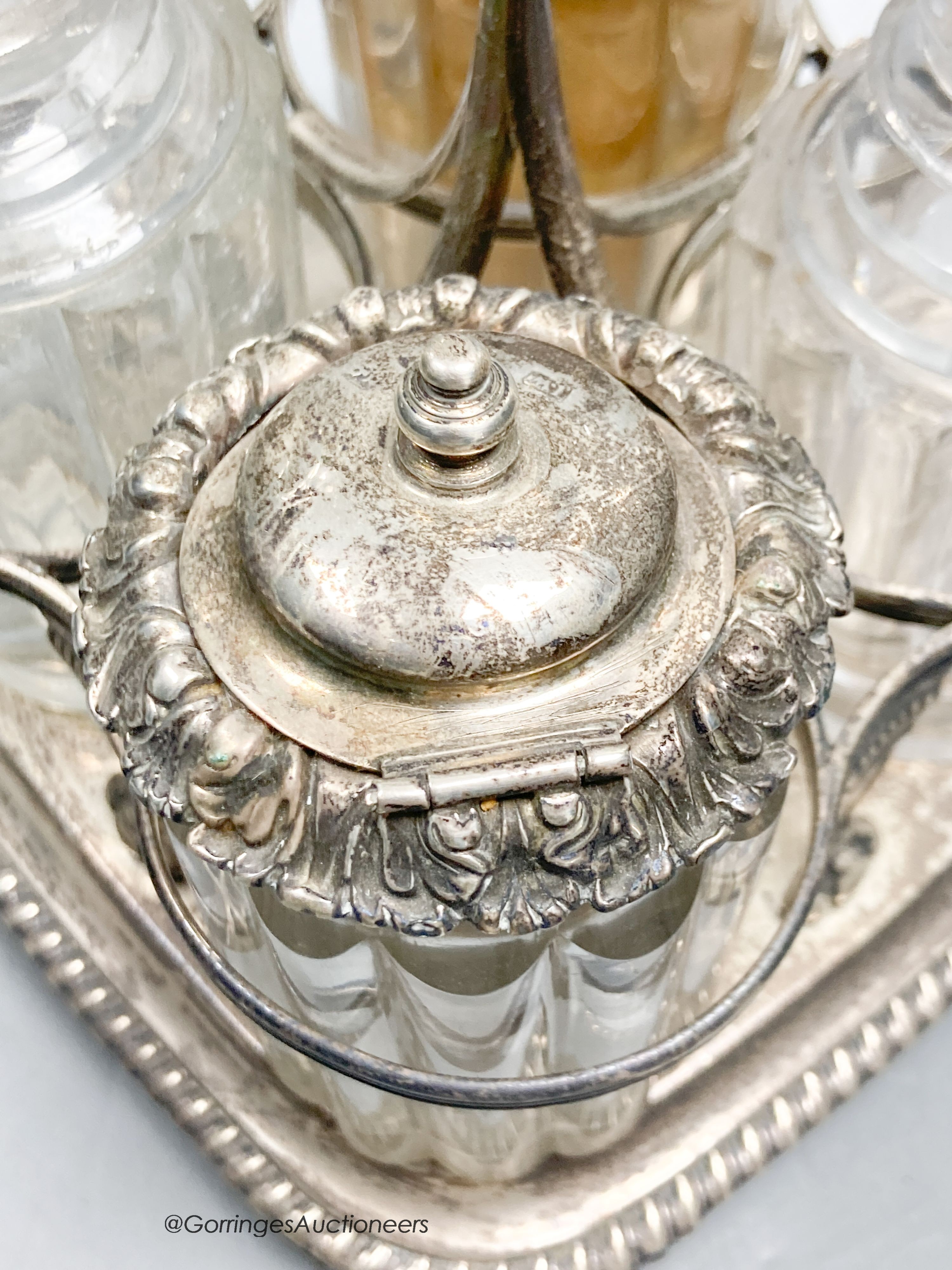 A George III silver cruet stand, by Emes & Barnard, London, 1813 and four associated cruets, two with silver mounts, 21.5cm, 13.5oz.